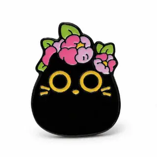 Black cat enamel pin with large yellow eyes, pink flowers, green leaves and gold whiskers on a white background.